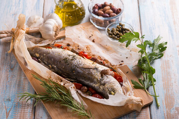 sea bass in foil with black olives tomatoes adn capers