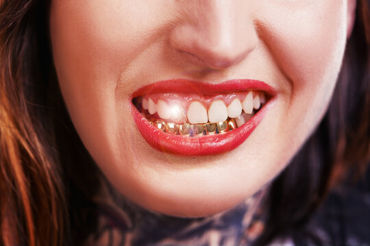 Woman, mouth and smile with gold teeth to shine for glamour and wealth with cosmetics. Closeup, dental jewelry and custom grill for fashion as female person with confidence, style and satisfied.