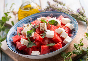 watermelon salad with feta cheese mint and lavender flowers - 767835744
