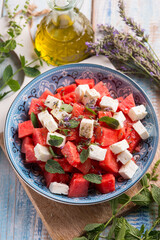 watermelon salad with feta cheese mint and lavender flowers - obrazy, fototapety, plakaty
