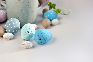 Easter eggs on a white table with space for text. Can be used as a greeting card. The minimal concept