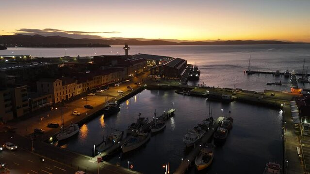 Drone view over Victoria Dock and old buildings line at sunrise in Hobart, Tasmania, Australia