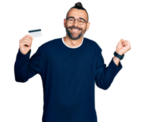 Hispanic man with ponytail holding credit card screaming proud, celebrating victory and success very excited with raised arm