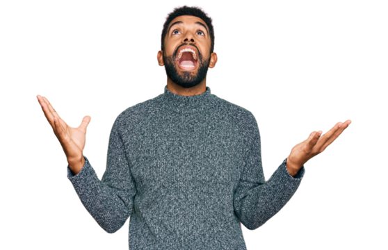 Young african american man wearing casual clothes crazy and mad shouting and yelling with aggressive expression and arms raised. frustration concept.