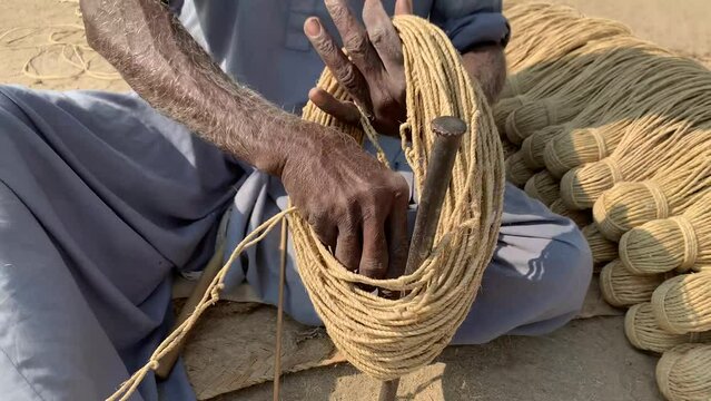 Hand Made Ropes In Pakistan. making ropes with hand for sleeping bed known as charpai in Pakistan. Different achievements of knot and assembly of boat ropes. Man is becoming a ropes. 4K Footage.