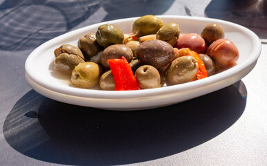 Green olives and pimentos in a bowl