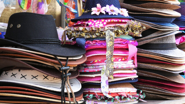 Colorful hats displayed in a street shop