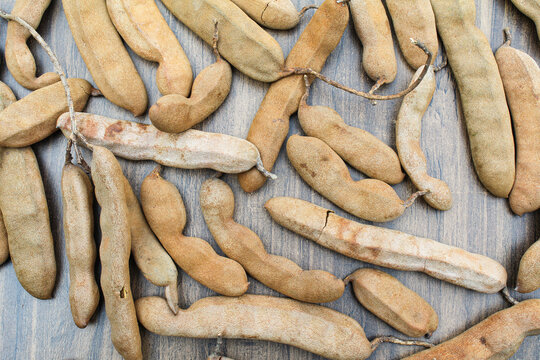 Tamarind fruits on wooden background top view 