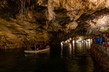 People in the boat on lake in amazing Drach Caves in Mallorca, Spain, Europe - 767861583