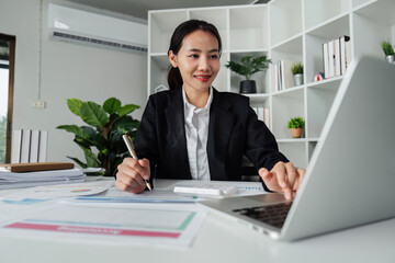 business woman entrepreneur in office using laptop at work, professional female company executive wearing suit working on computer at workplace