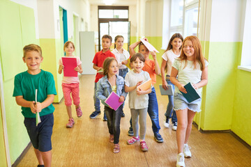School children walking with books in corridor