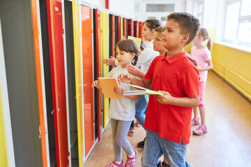 Schoolkids keeping books in lockers - Powered by Adobe