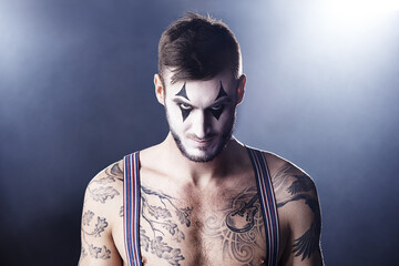 Man, mime and topless for theatre performance with dark background with light for stage, creativity and entertainment. Portrait, circus or magician performer and face paint with tattoo for show - obrazy, fototapety, plakaty