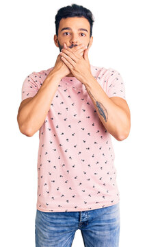 Young handsome hispanic man wearing casual clothes shocked covering mouth with hands for mistake. secret concept.