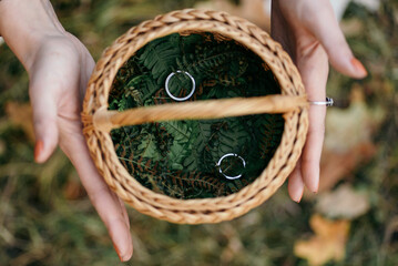wooden basket with wedding rings