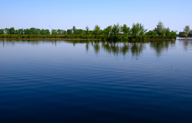 Landscape of a lake and blue sky reflected. - 767879945