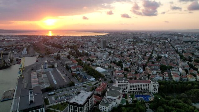 Aerial movie, seascape of the Burgas bay, sea garden, and city. Sunset sky with clouds and the Black Sea coast, Bulgaria