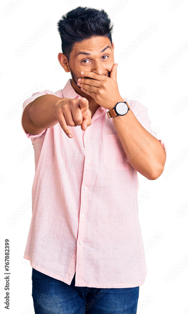 Poster handsome latin american young man wearing casual summer shirt laughing at you, pointing finger to th