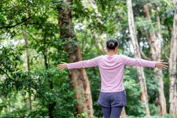 Woman exercising and stretching in park