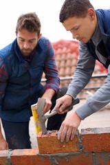 Construction, bricklayer and men with tools for building a brick wall, handyman or contractor with...
