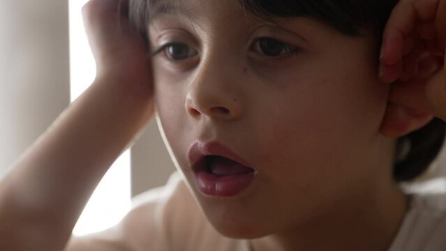 Lazy Drowsy Youngster in Deep Thought, Close-Up of Bored Little Boy Pondering. Close-up face of bored male caucasian kid