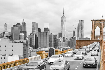 Brooklyn Bridge isolated in color against a black and white view of downtown Manhattan and its...