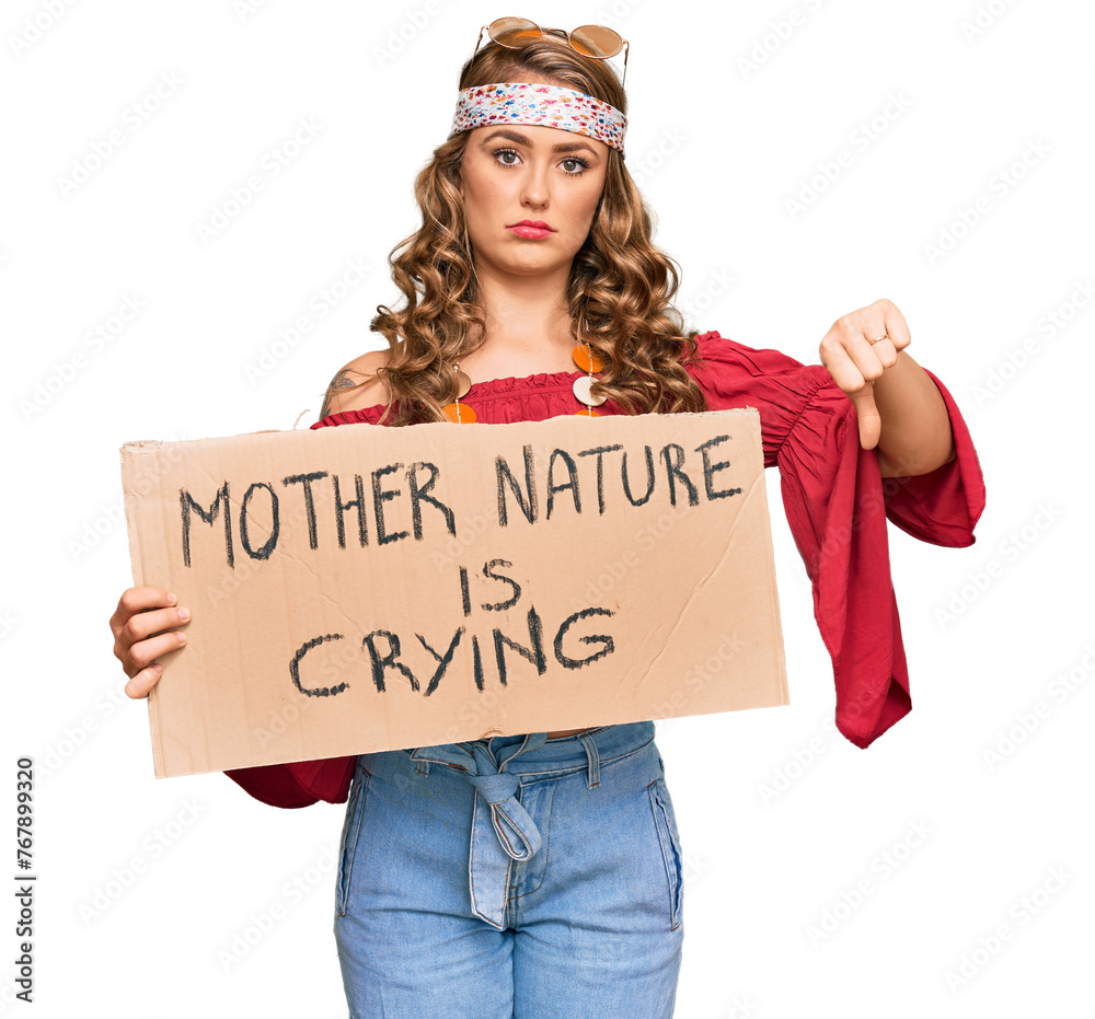 Wall mural young blonde girl wearing hippie style holding mother nature is crying protest cardboard banner with