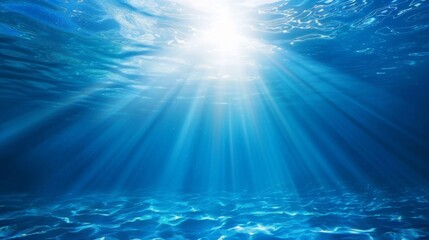 Fototapeta na wymiar Ocean background - Sun shining light sunlight sunshine in blue clearly deep water, sunbeams illuminate the blue underwater sea scene
