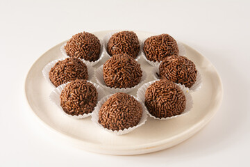 Chocolate truffle balls Brigadeiro brazilian candy and chocolate flakes front view clean background