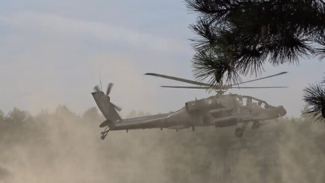 Military Helicopter Flying Low through sand