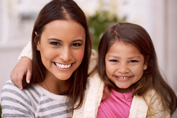 Portrait, mother and daughter with smile in lounge of home with love, care and happiness. Apartment, mom and girl together to relax on sofa or couch with hug for bonding in living room of house