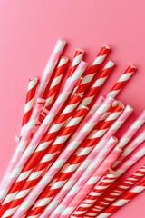 Striped paper straws on a yellow background. Flat lay composition with copy space.