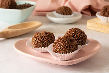 Chocolate truffle balls Brigadeiro brazilian candy and chocolate flakes front view clean background