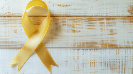 Flatlay gold satin cancer ribbon timber wash background  childhood copd pediatric child support awareness month charity treatment survivor copy space banner medical