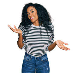 Middle age african american woman wearing casual clothes clueless and confused expression with arms...