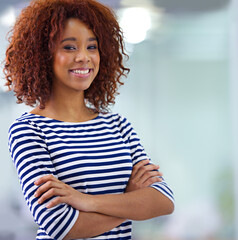 Fototapeta premium Portrait, arms crossed and happy business woman in office at startup company in South Africa with bokeh or mockup space. Face, confidence and smile of creative professional, employee and designer