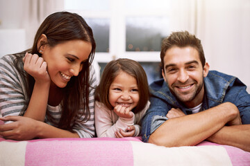 Portrait, family or smile in bed to relax, love or trust in diversity, bonding or together in...