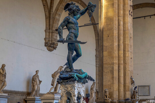 Detail of Perseus holding head of Medusa, bronze statue in Loggia de Lanzi, Piazza della Signoria, Florence, Italy. Isolated on white