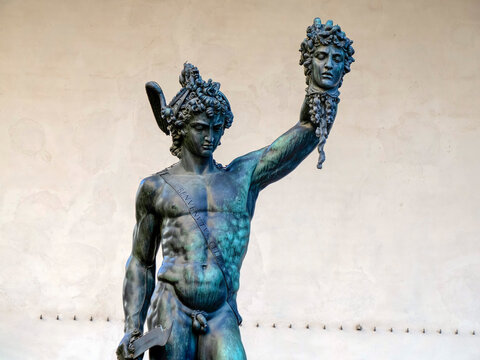 Detail of Perseus holding head of Medusa, bronze statue in Loggia de Lanzi, Piazza della Signoria, Florence, Italy. Isolated on white
