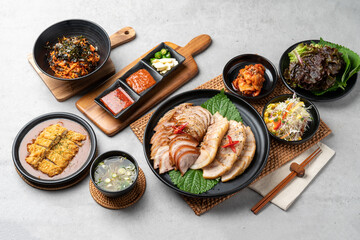 Korean food, pig's feet, spicy, bossam, pork, boiled pork, oysters, side dishes, kimchi, cabbage, perilla leaves, cabbage, garlic, pepper, pork cutlet - obrazy, fototapety, plakaty