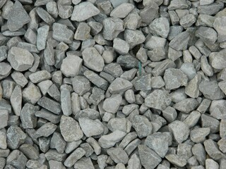 Light blue and white gravel texture background featuring large rocks