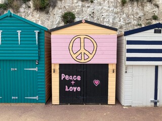 Beach hut with painted peace sign, on the coast in Broadstairs, Kent, UK