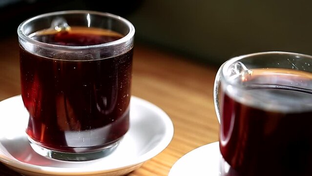 Closeup video of two cup of coffee on the blurred background