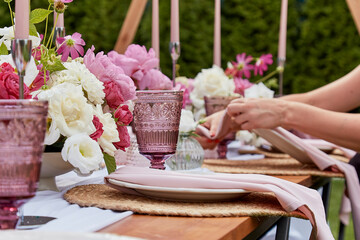 Picnic aesthetics table setting, flowers arrangement. Arrangement for party planning and decoration.