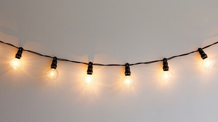 hanging string of lights on a white background  - obrazy, fototapety, plakaty