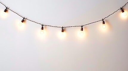 hanging string of lights on a white background   - obrazy, fototapety, plakaty