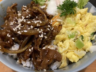 Bulgogi with a combination of blackpepper sauce and served with rice, onions and vegetables.