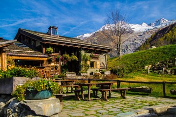 Quaint house situated in a valley surrounded by majestic mountains. France.