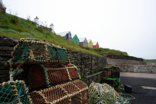 Collection of several fishing nets are pictured sitting on the side of a road