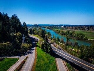 Fototapeta na wymiar Aerial view of a freeway bridge crossing over a river in Eugene